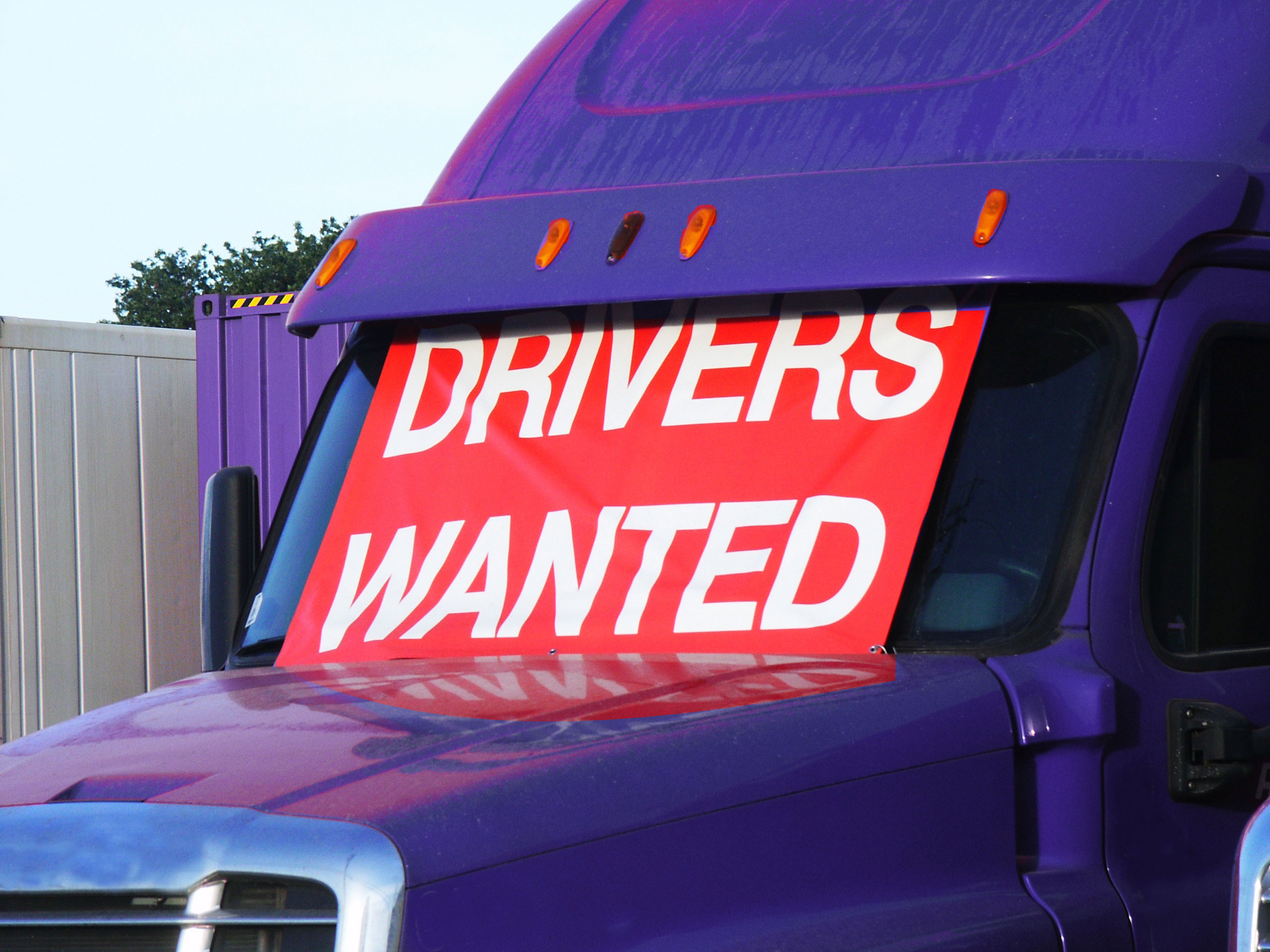 CDL driver in cab, representing the drivers carriers are competing to hire